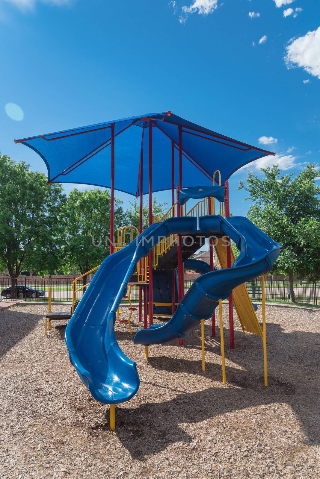Neighborhood playground with colorful structure equipment near Dallas, Texas by trongnguyen