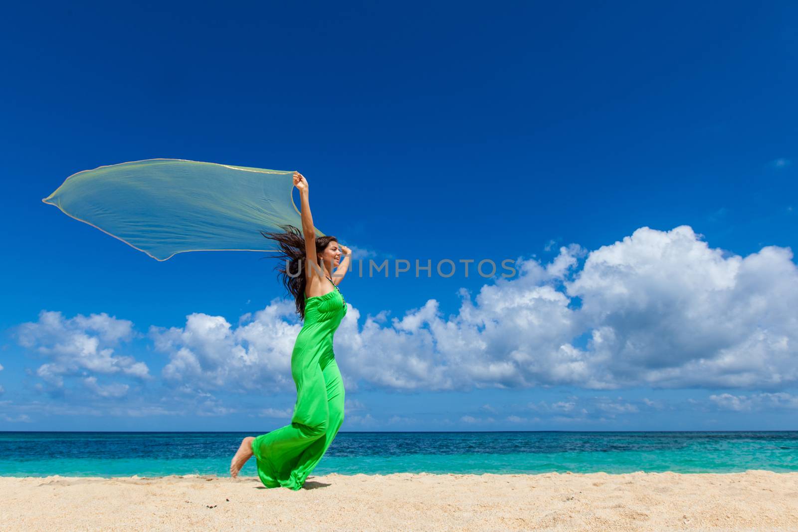 Woman in dress run on beach by Yellowj