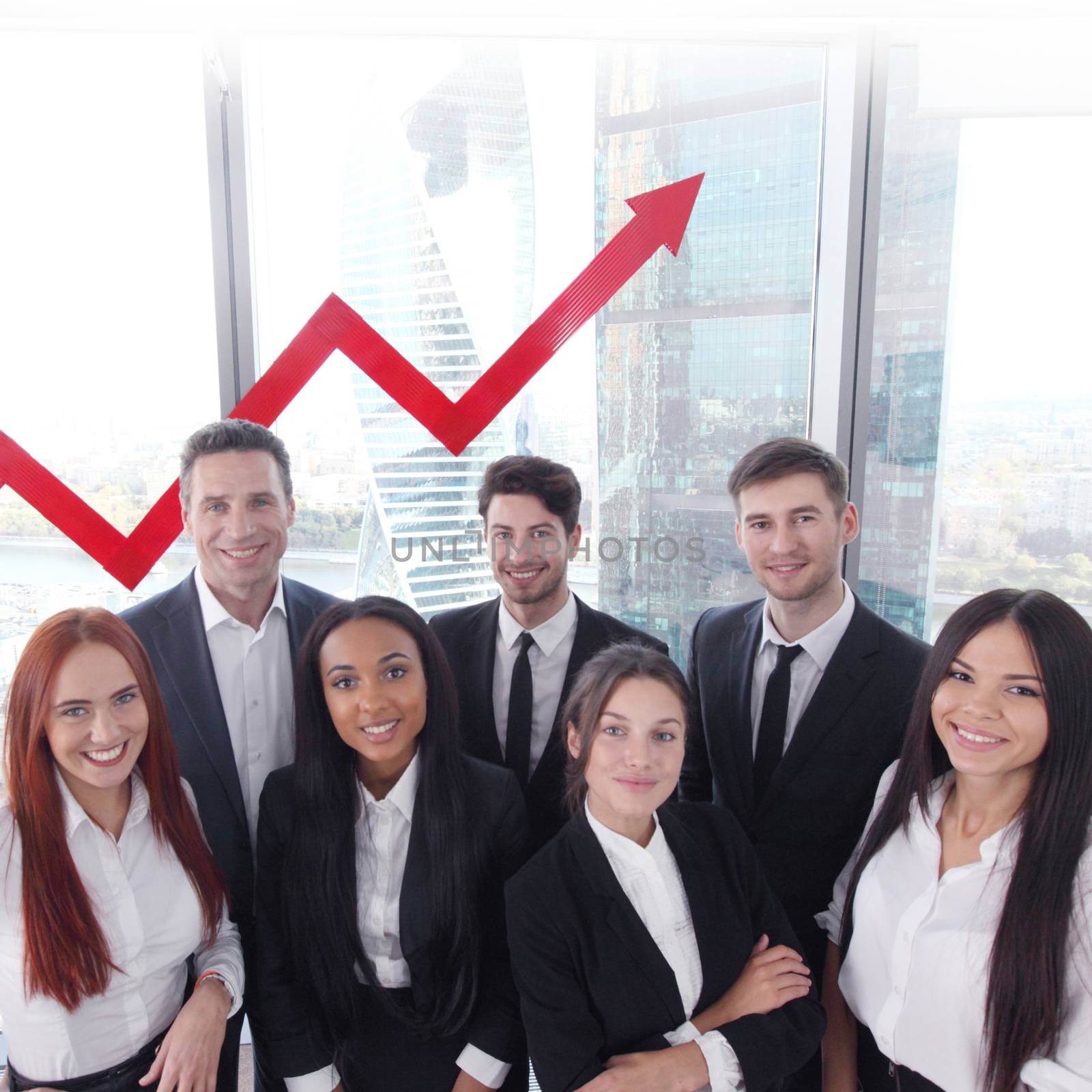 Portrait of business team of men and women in office with arrow graph of income growth