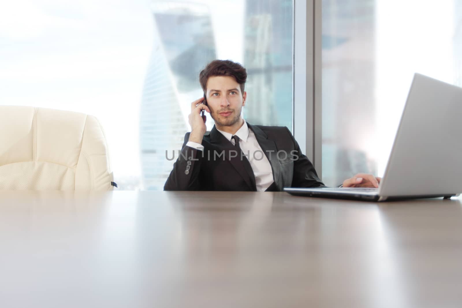 Busy businessman in office working on his laptop