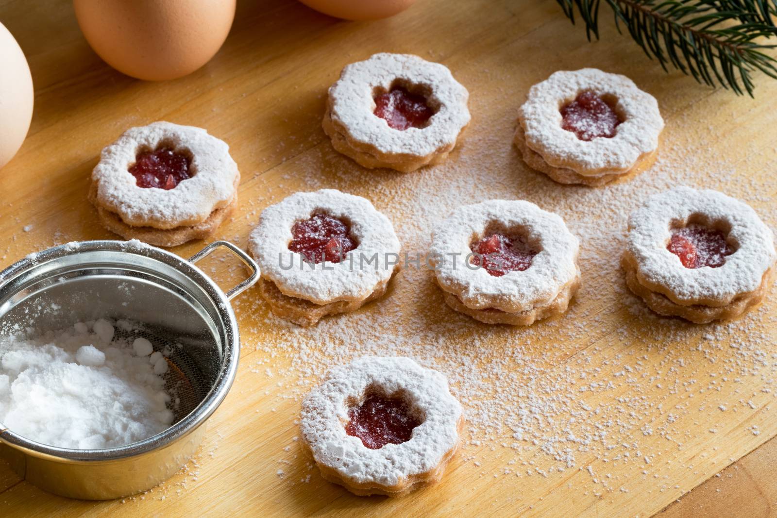 Traditional Linzer Christmas cookies dusted with sugar on a table