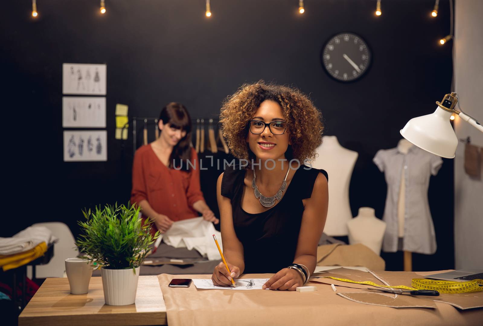 Two young entrepreneur women, and fashion designer working on her atelier