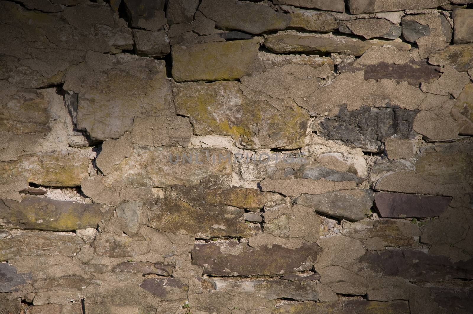 Cracked dilapidated masonry wall lit diagonally by Balefire9