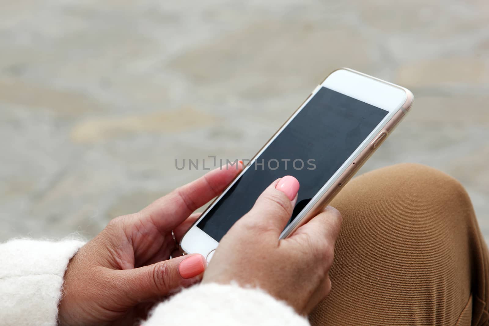 Young Girl Uses His Cell Phone To Check Your Electronic Mail.