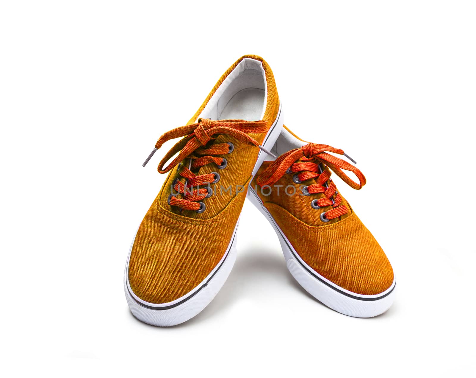 A pair of orange color canvas shoes isolated on white background with clipping path