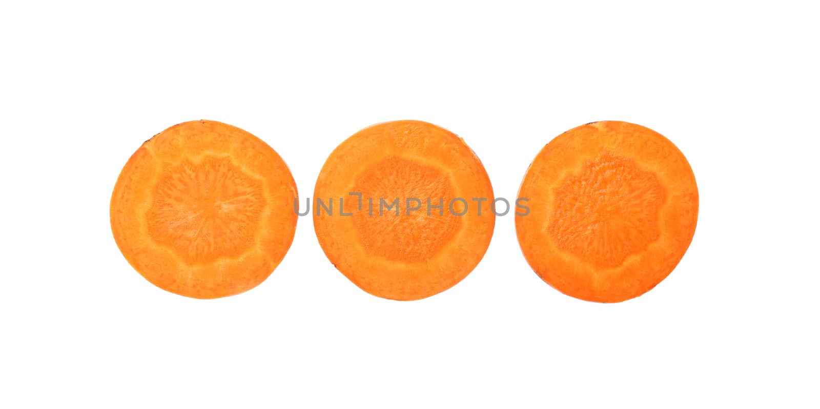 Close up three round thin cut slices of fresh carrot, backlit and isolated on white background