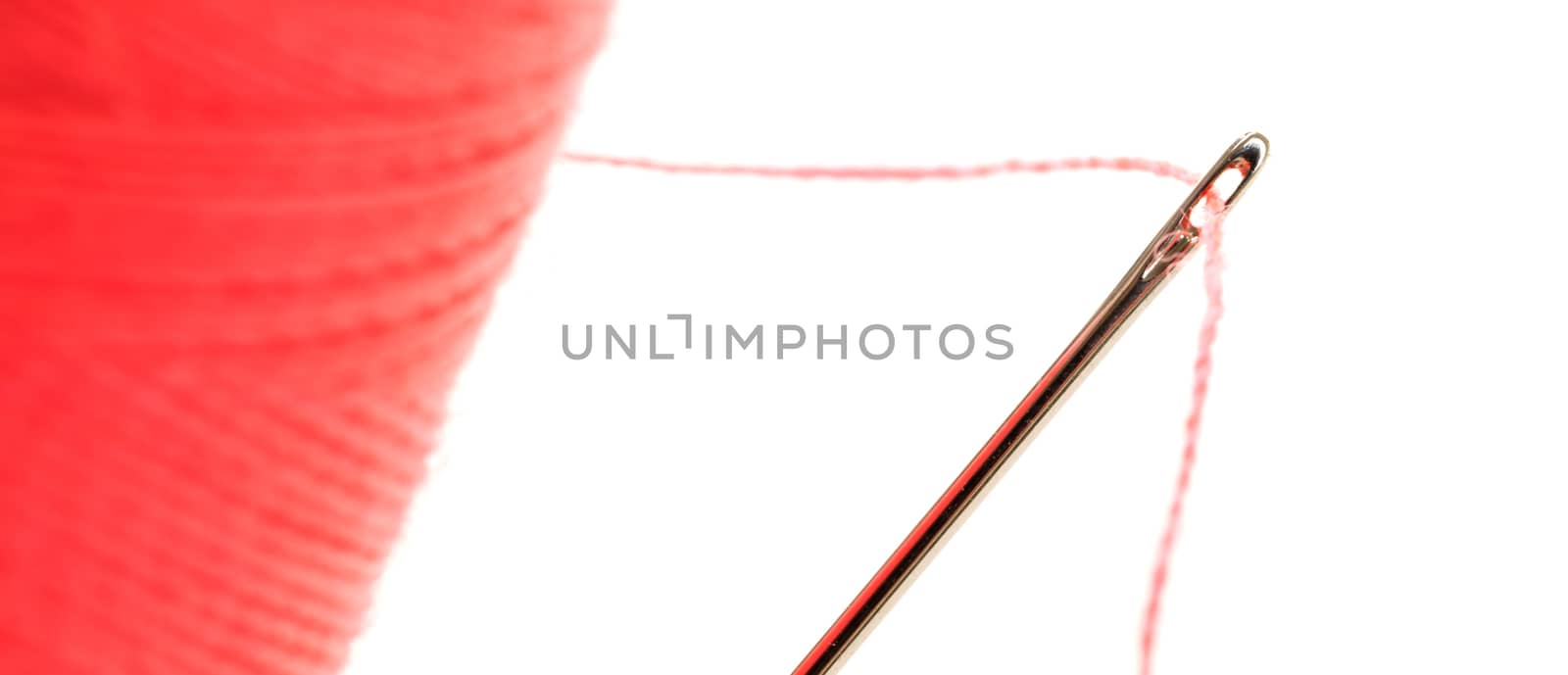 Sewing thread with needle isolated on a white background