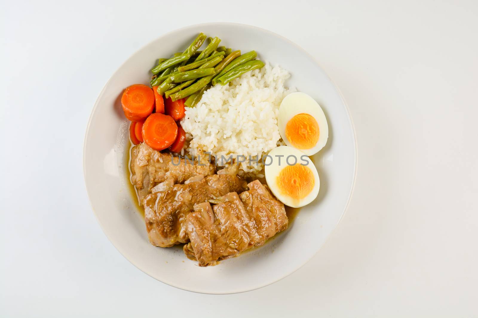 Baked pork ribs with rice, boiled egg and vegetable