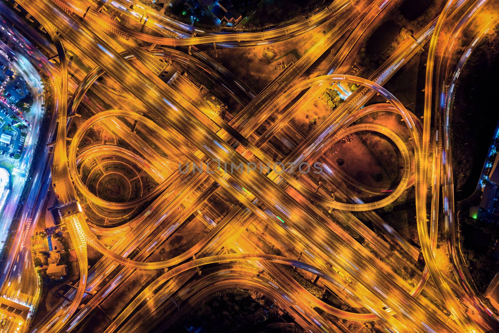 Aerial view of traffic on massive highway intersection at night. by gutarphotoghaphy