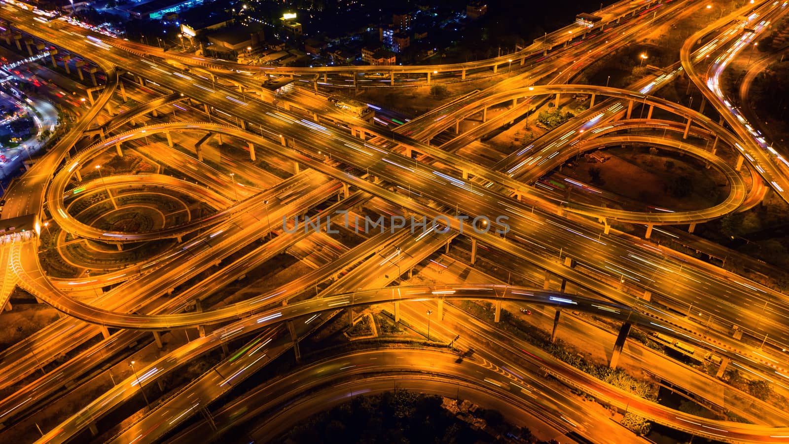 Aerial view of traffic on massive highway intersection at night. by gutarphotoghaphy