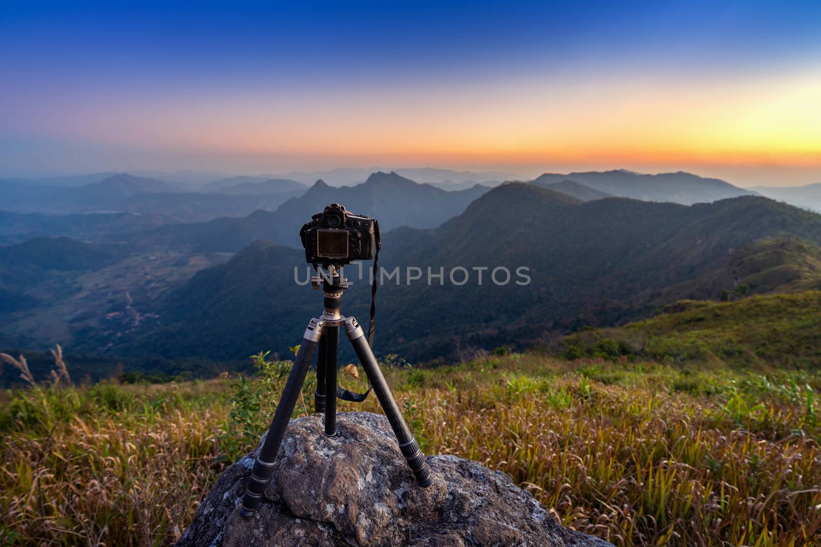 Digital camera on tripod in the mountains.