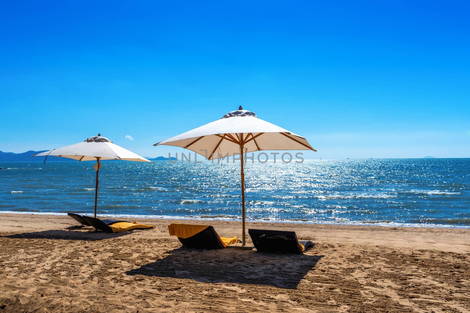 Chairs and umbrella on a tropical beach. by gutarphotoghaphy