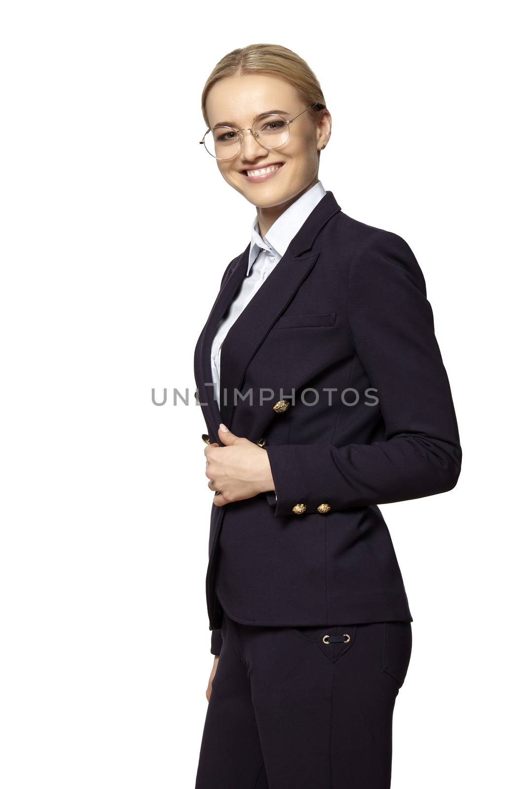 Studio portrait of young happy smiling business woman in a gold eyeglasses and dark business suit.
