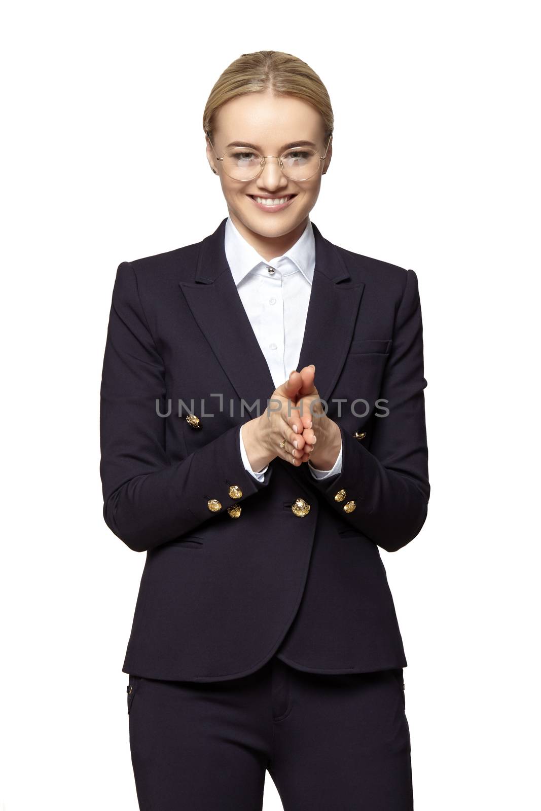 Satisfied attractive young woman stands with folded hands. Studio shot isolated on white background. 