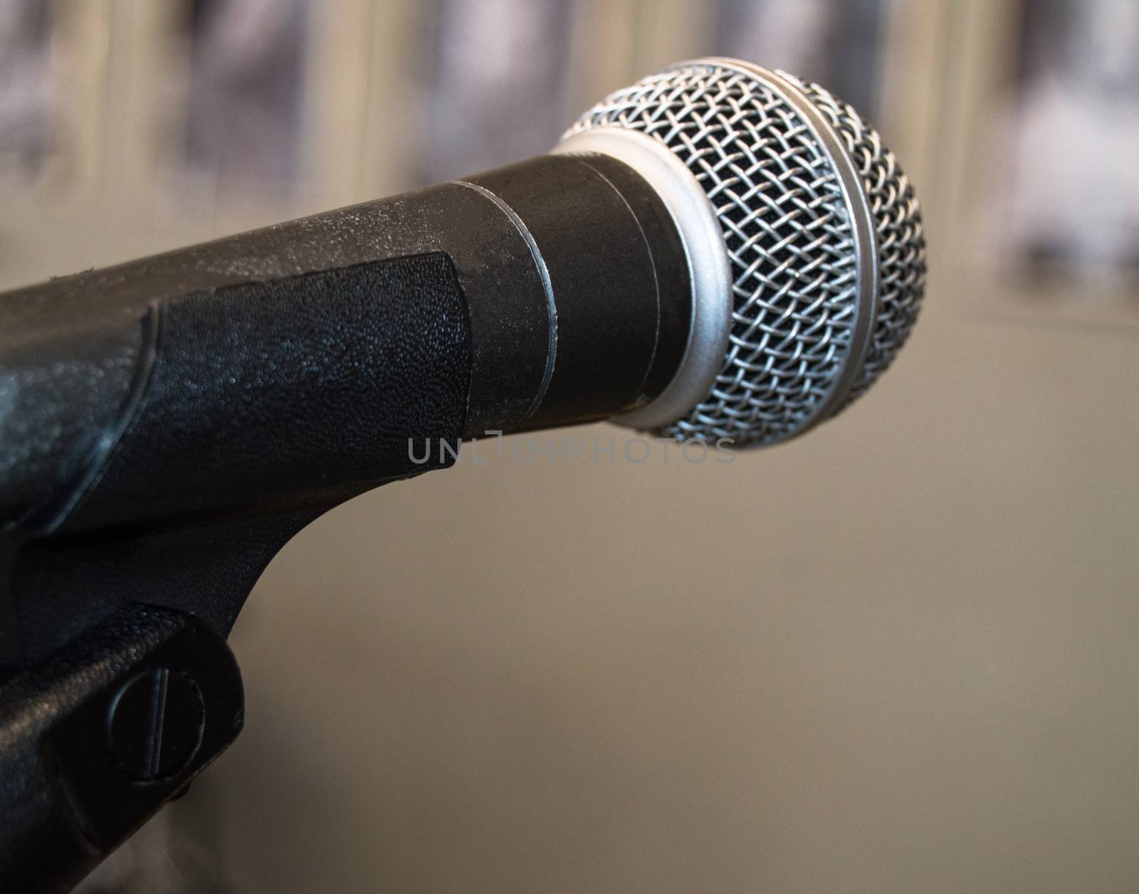 Microphone close-up, used by speaker to speak in conference room, seminar, University, lectures, blurred background.