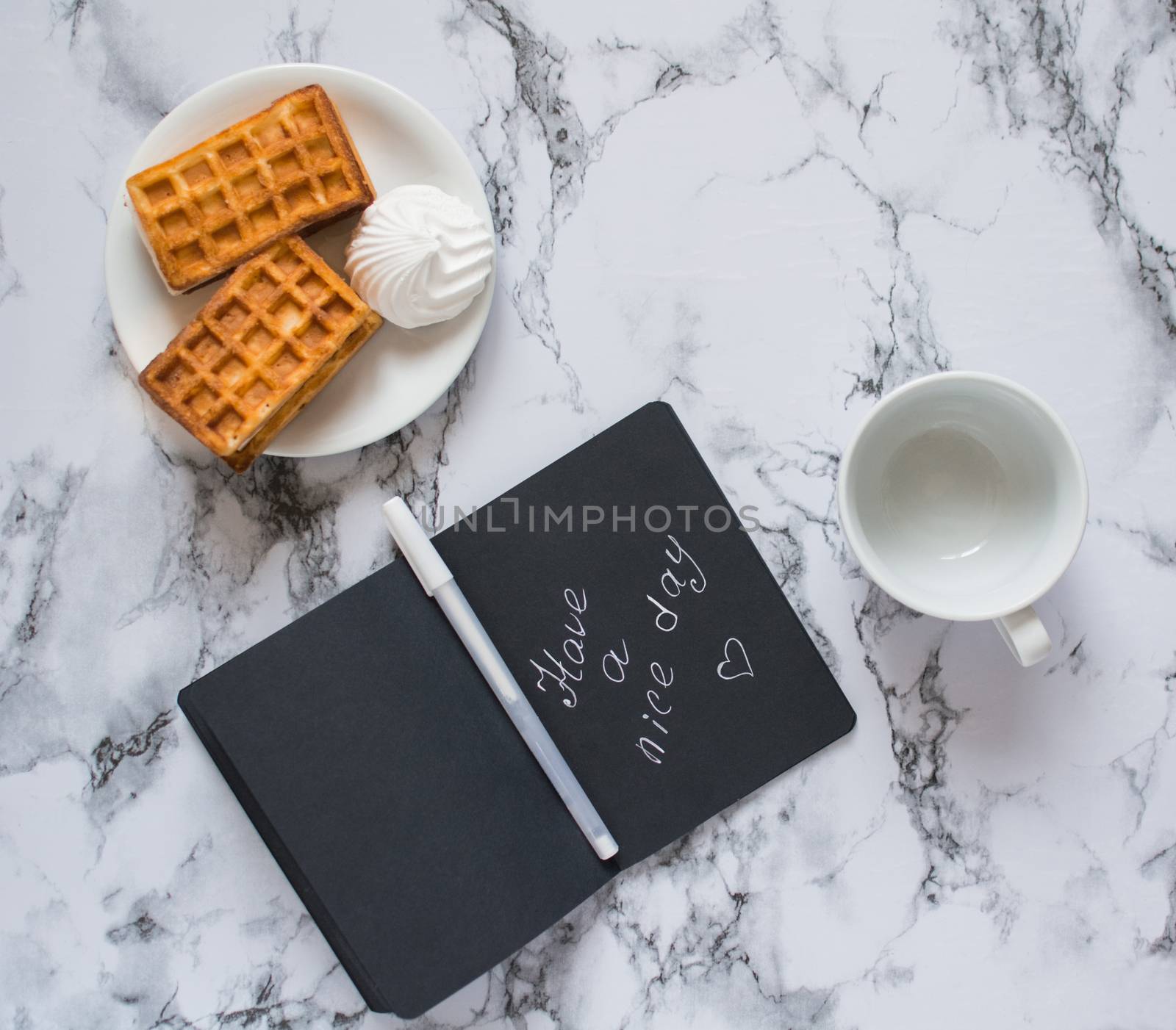 black notebook with lettering on marble background lunch by Izumepho