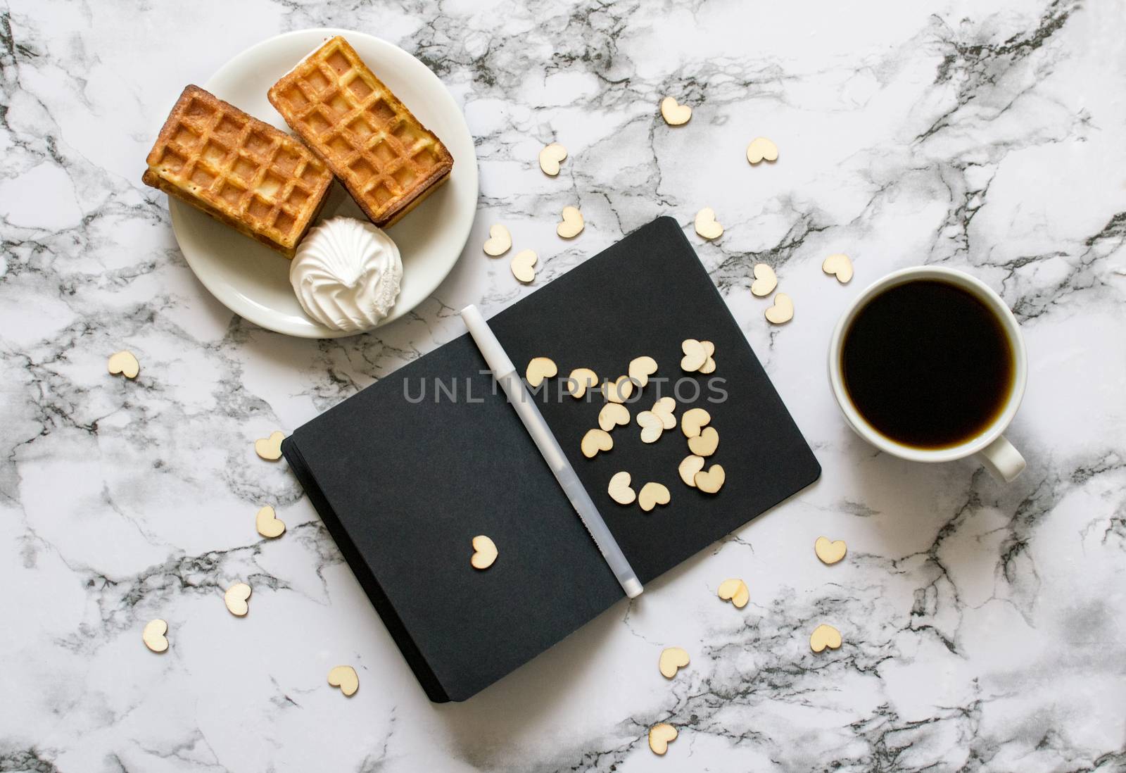 notebook with black sheets on marble background and coffee by Izumepho