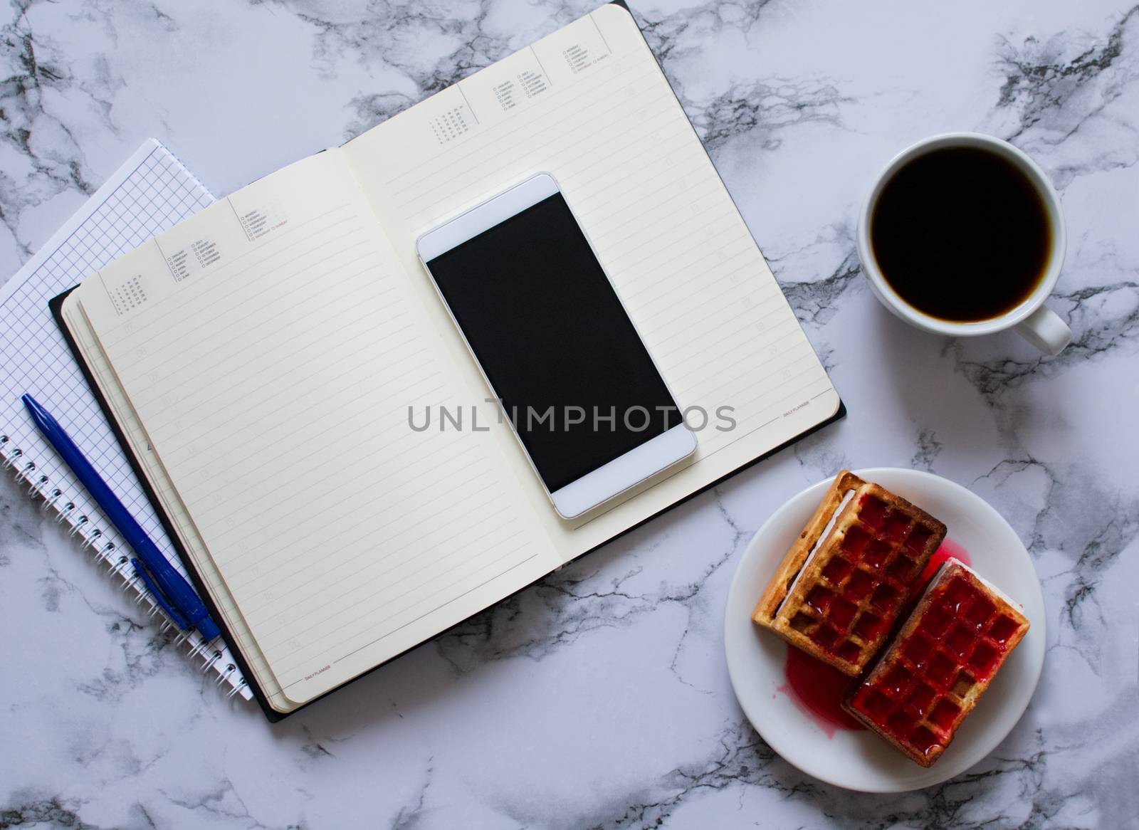 two planners on marble background, coffee, waffles and smartphone by Izumepho