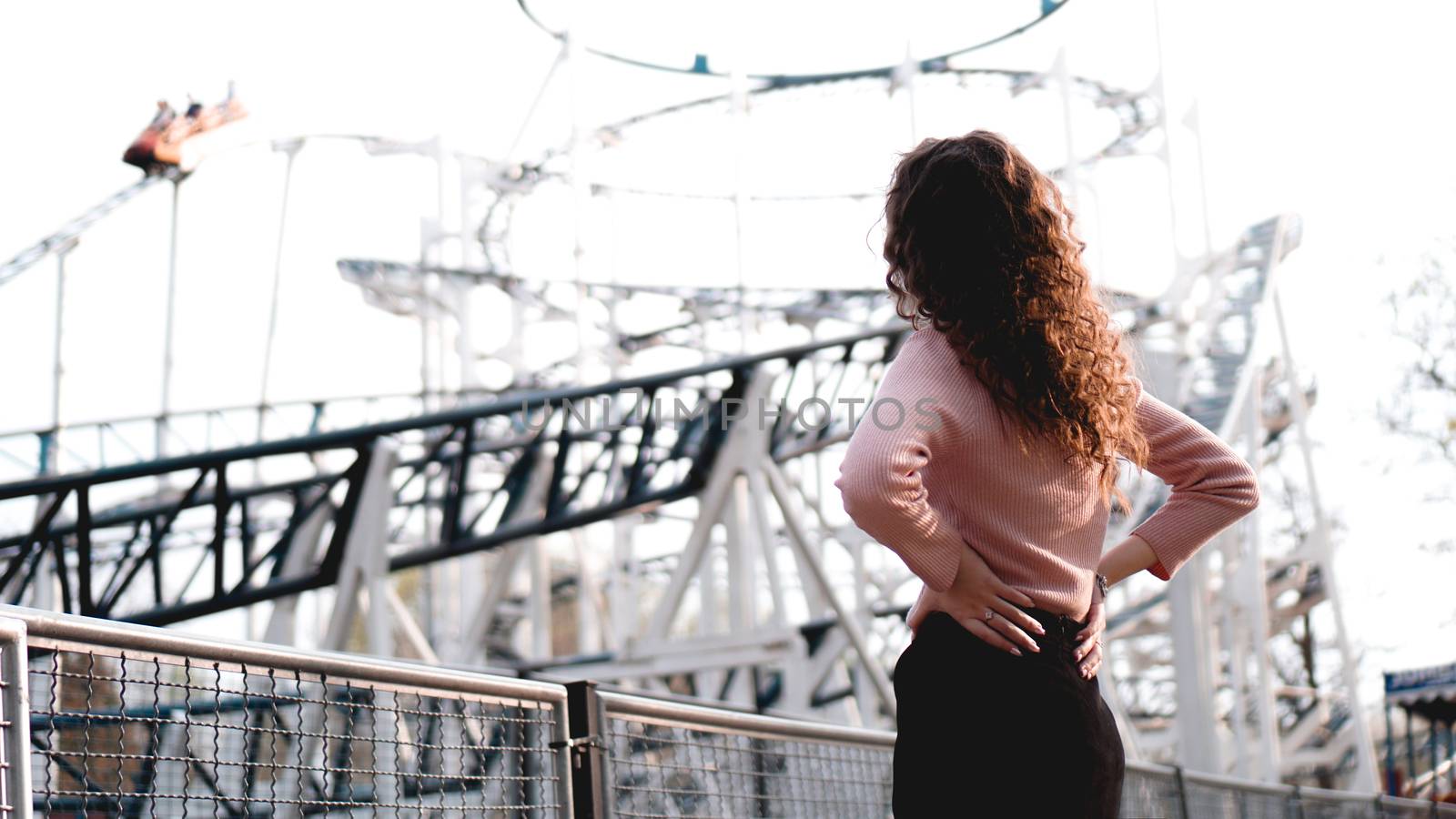 Beautiful smiling girl on a background of a roller coaster by natali_brill