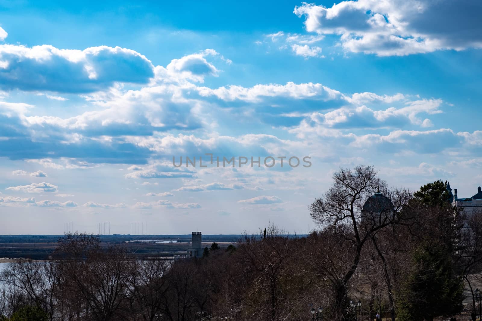 View of the Amur river against the blue sky with white beautiful clouds. Bright spring sun. Russia, Khabarovsk. by rdv27