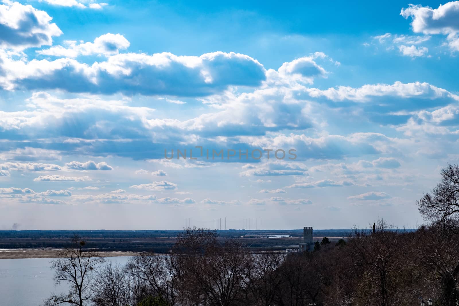 View of the Amur river against the blue sky with white beautiful clouds. Bright spring sun. Russia, Khabarovsk. by rdv27