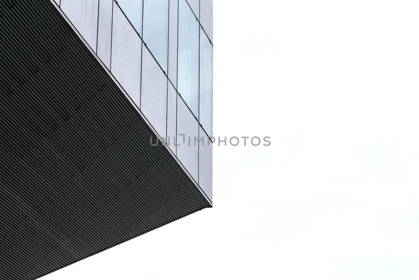 Clouds reflected in windows of modern office building. by Anelik