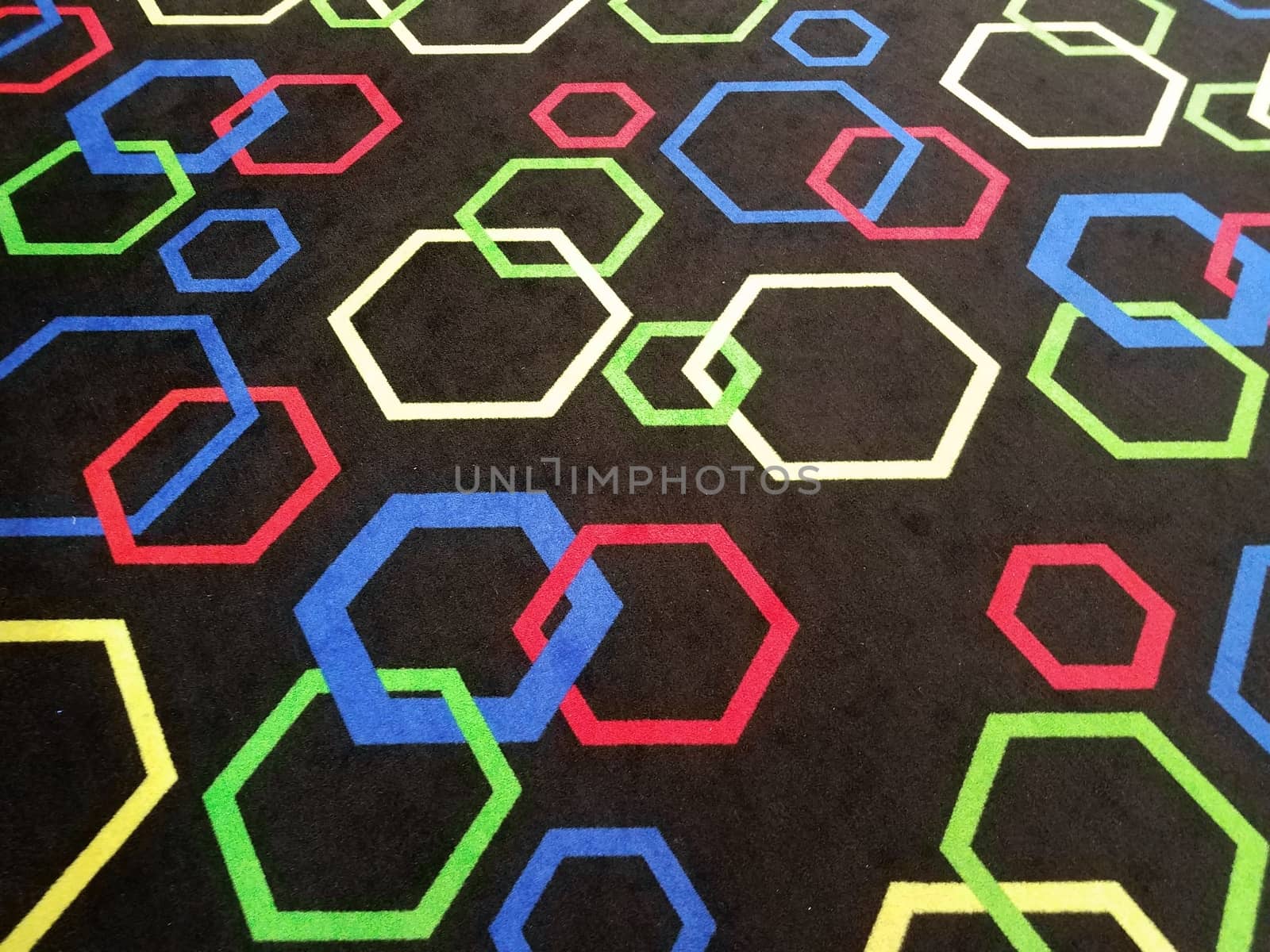 black carpet or rug or fabric with colorful hexagon shapes