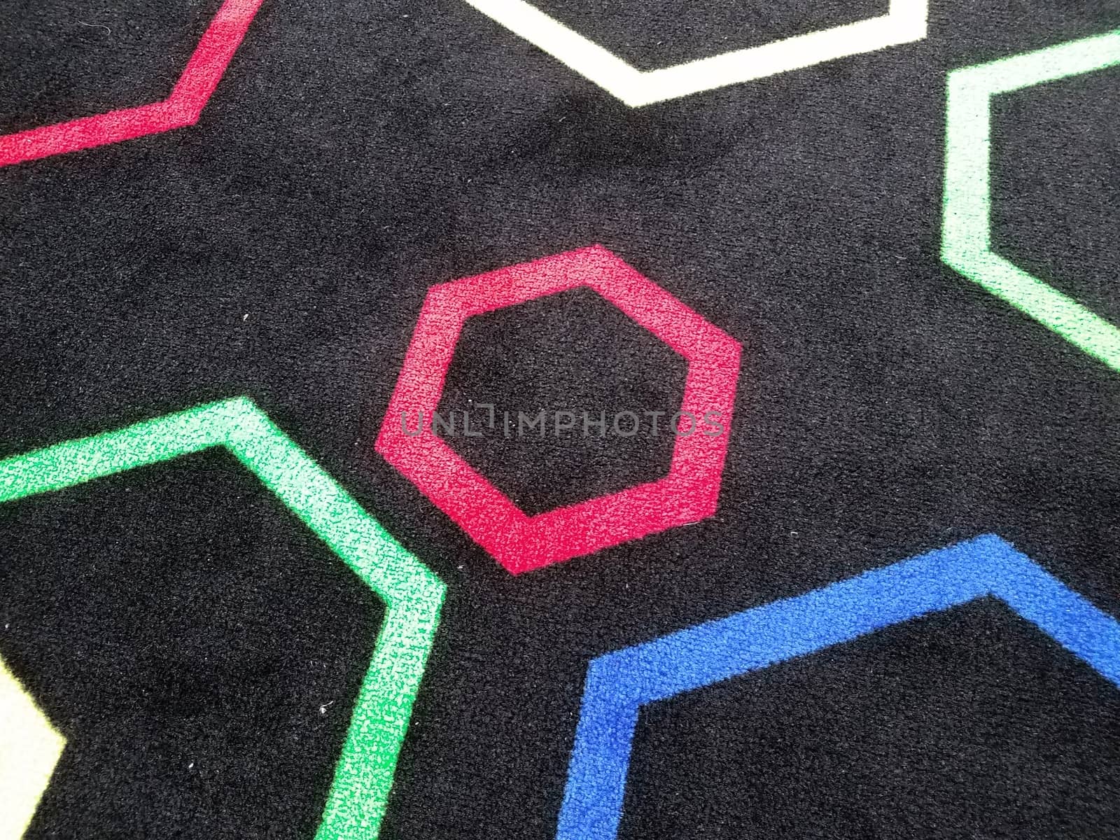 black carpet or rug with colorful hexagon shapes by stockphotofan1