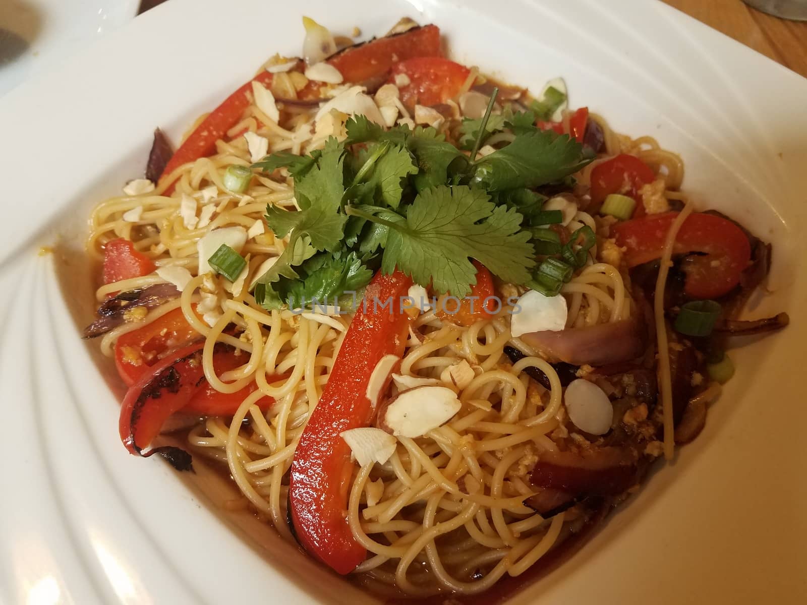 asian noodles with red bell peppers and cilantro and nuts