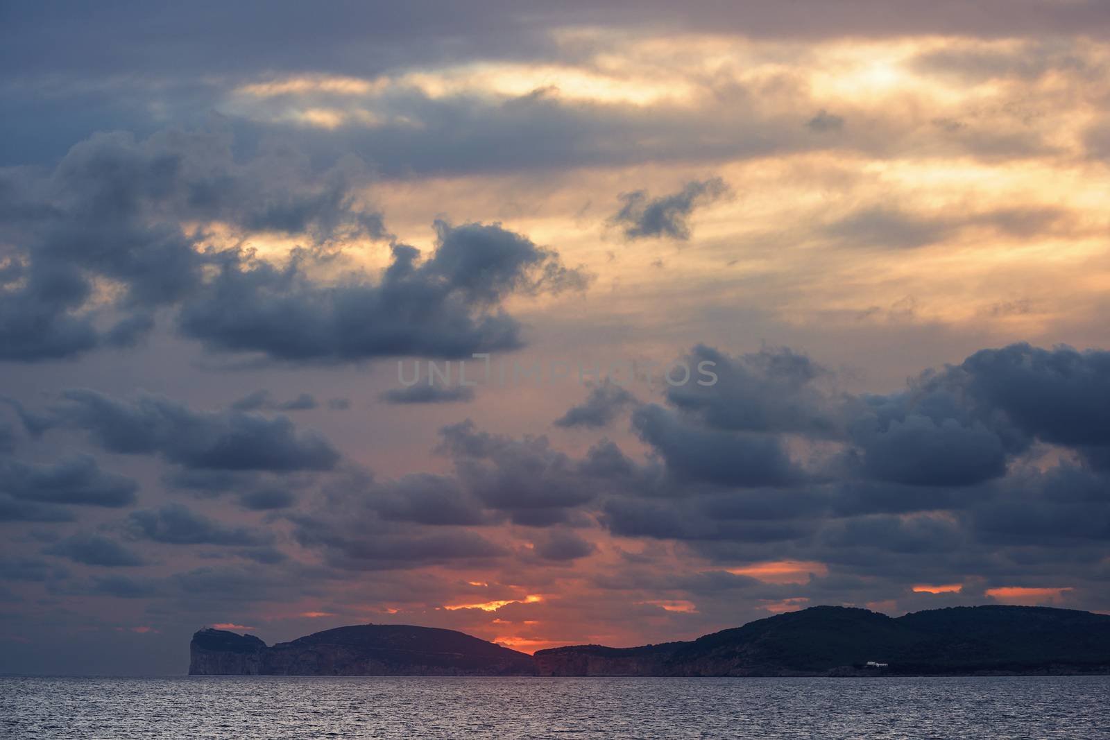 spectacular sunset on the giant that sleeps in Alghero, Sardinia, Italy