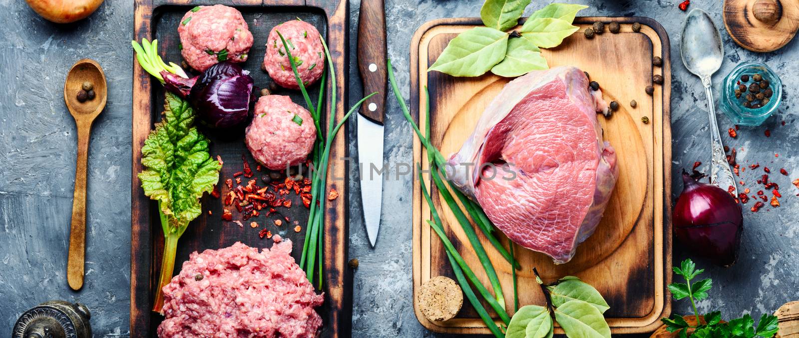 Meat balls from raw beef force-meat on kitchen board.Raw meat selection on wooden cutting board