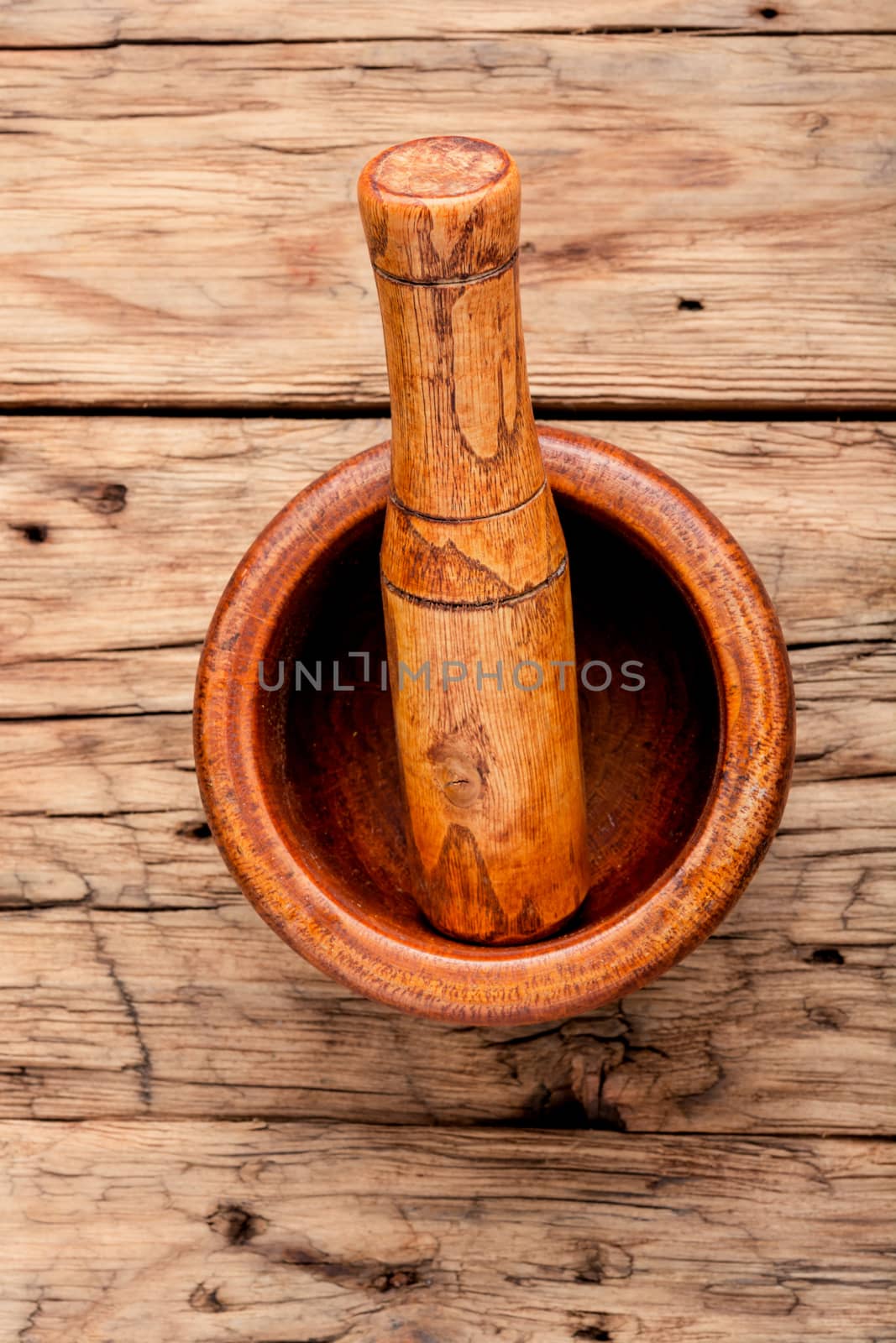 Empty wooden mortar and pestle on wooden old background