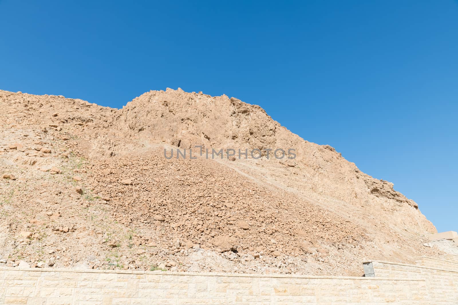 rock and blue sky in israel near masada by compuinfoto