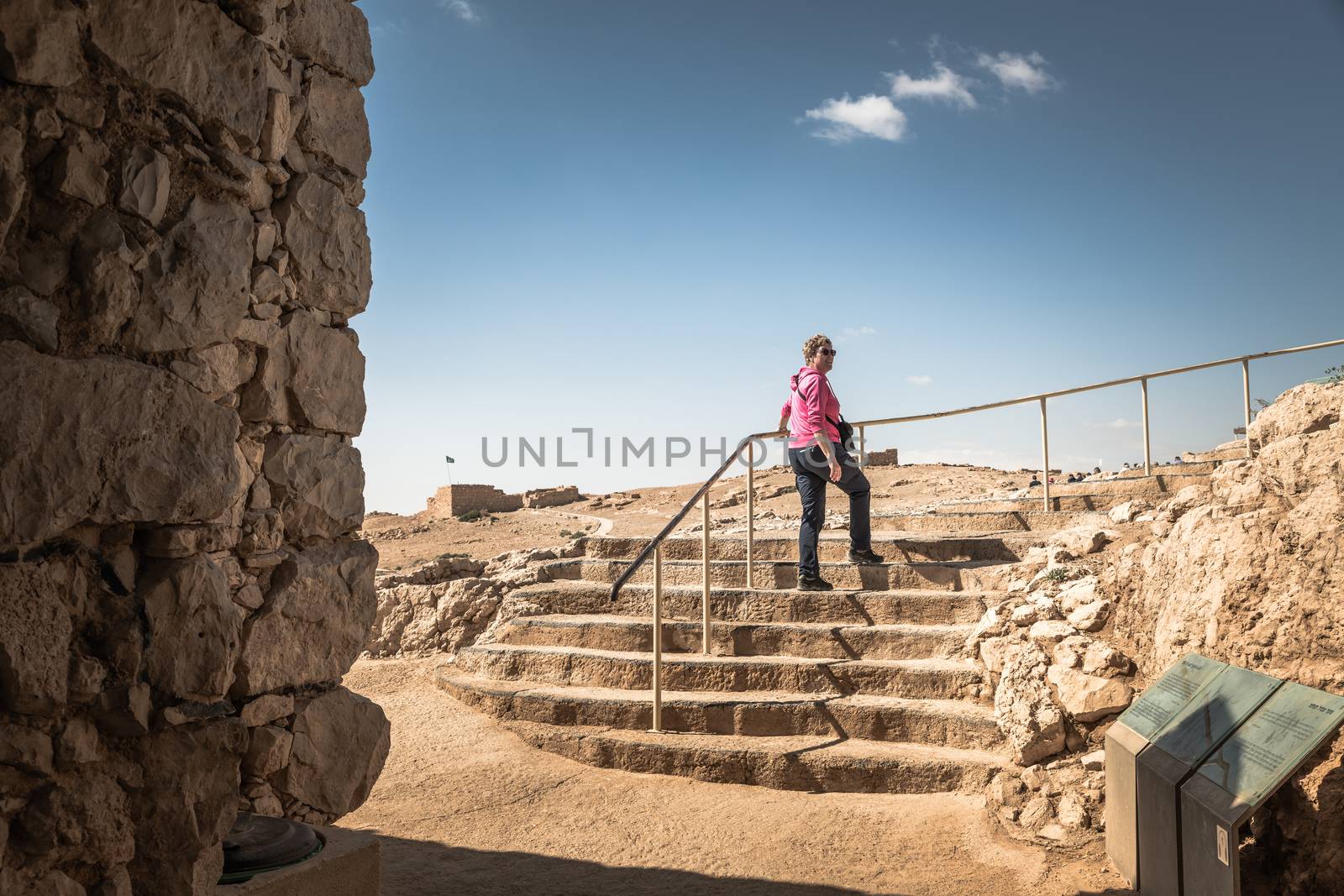 woman walking in masada national park on the ancient stairs