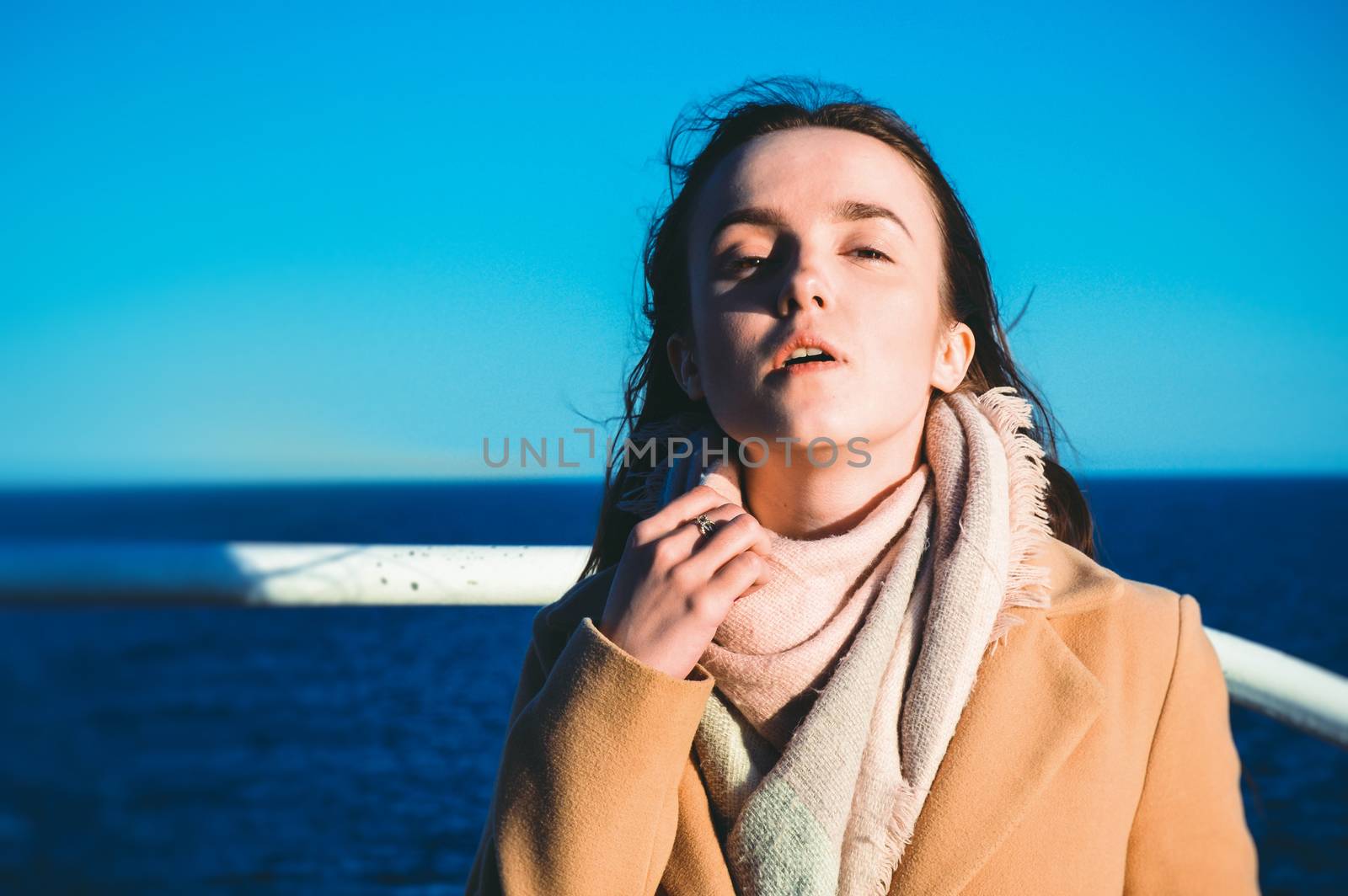 Close up portrait woman enjoying the sea from ferry. Sea life, spring vacations, casual wear, wind, pretty face, fashion portrait, model