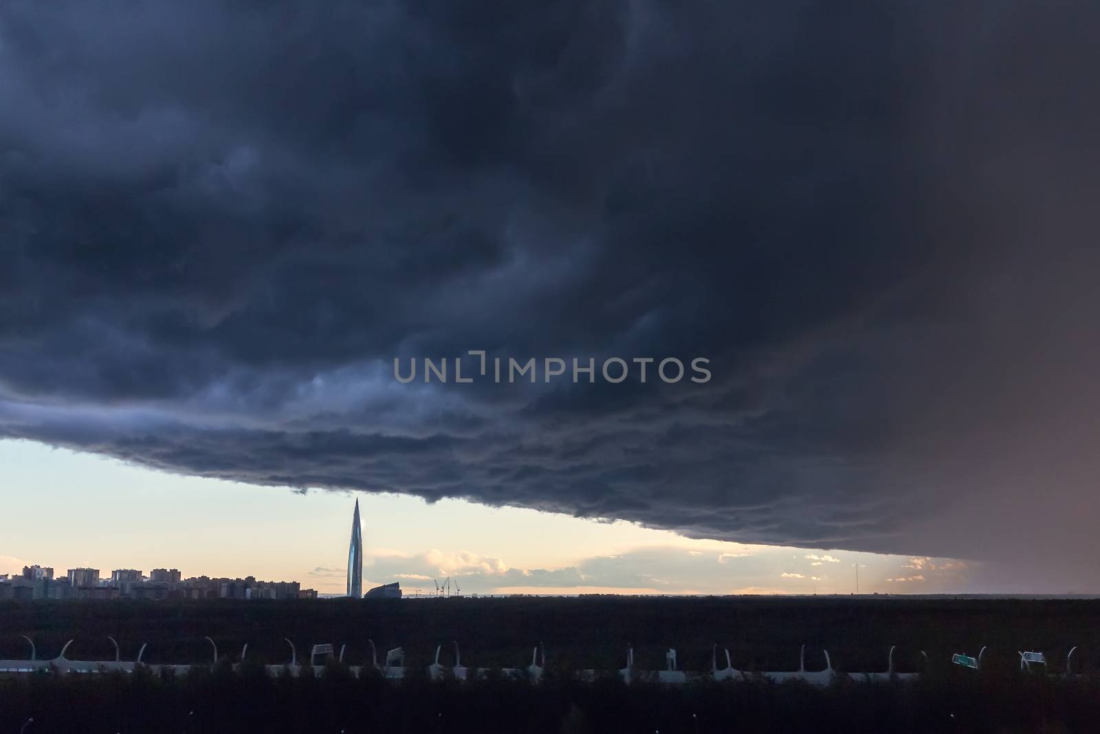 huge thundercloud on the outskirts of the city before the rain - image.