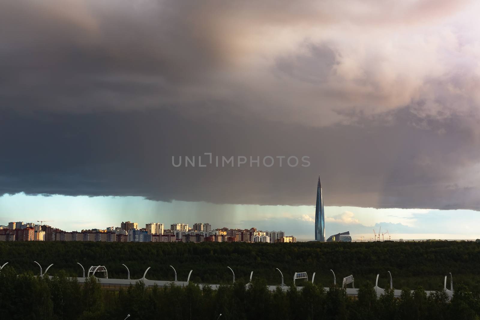 huge thundercloud on the outskirts of the city before the rain - image.