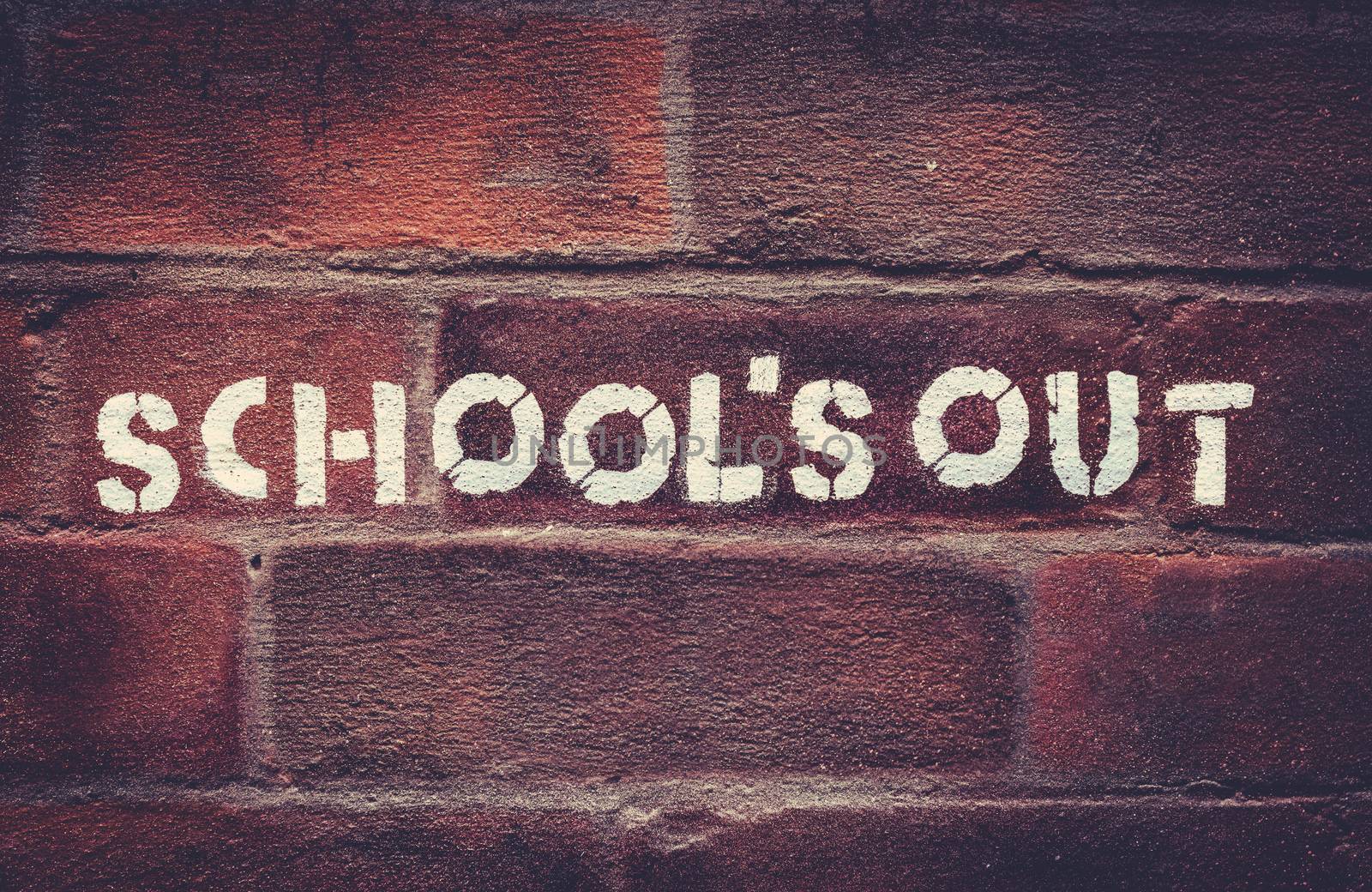 Urban School's Out Stencil Graffiti On A Red Brick Wall