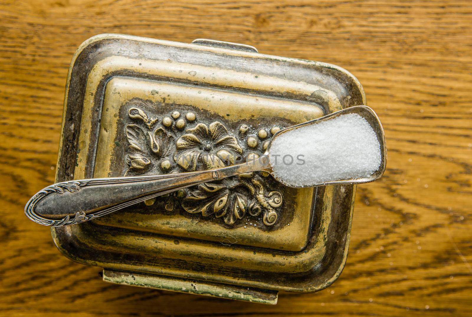 Sugar bowl in the form of a bronze box and a square spoon with sugar