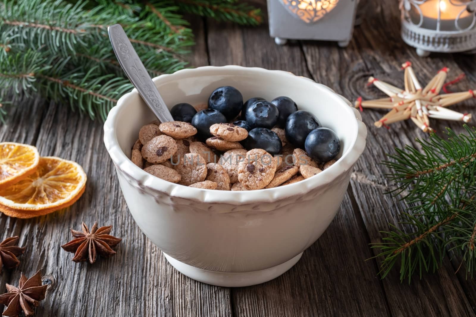 Breakfast cereals with blueberries, with spruce branches and Christmas decoration