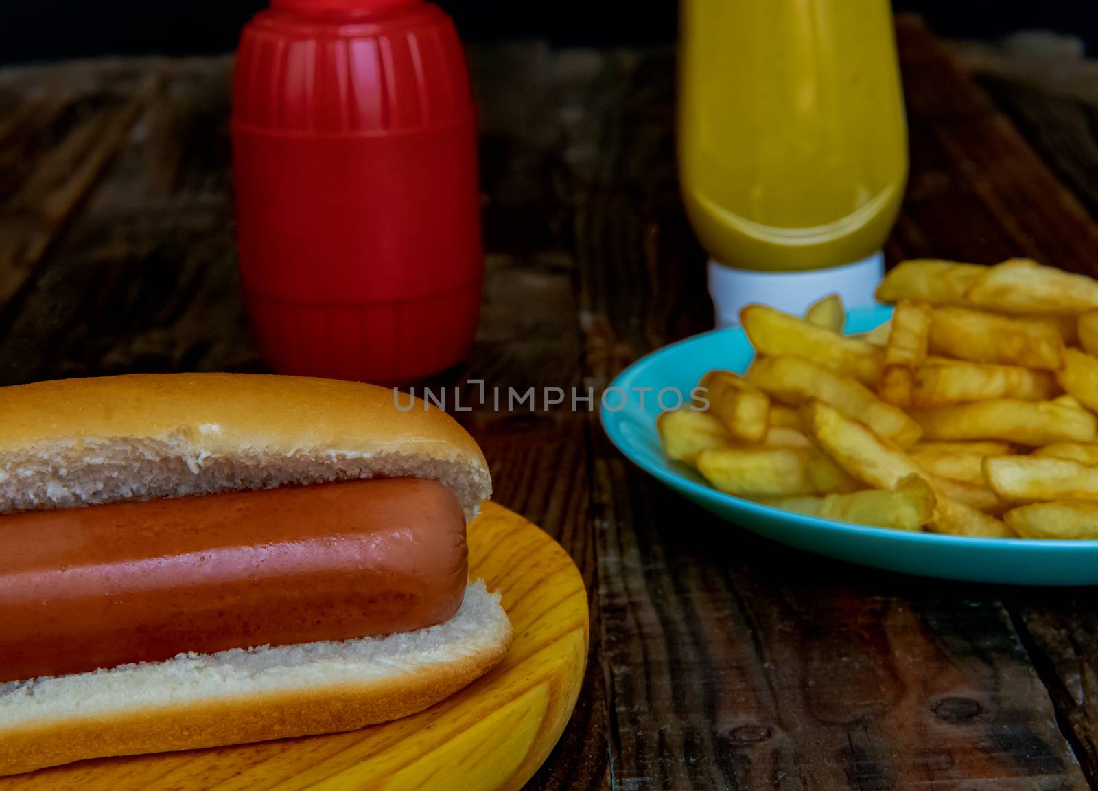 Hot dog and chips on wooden background