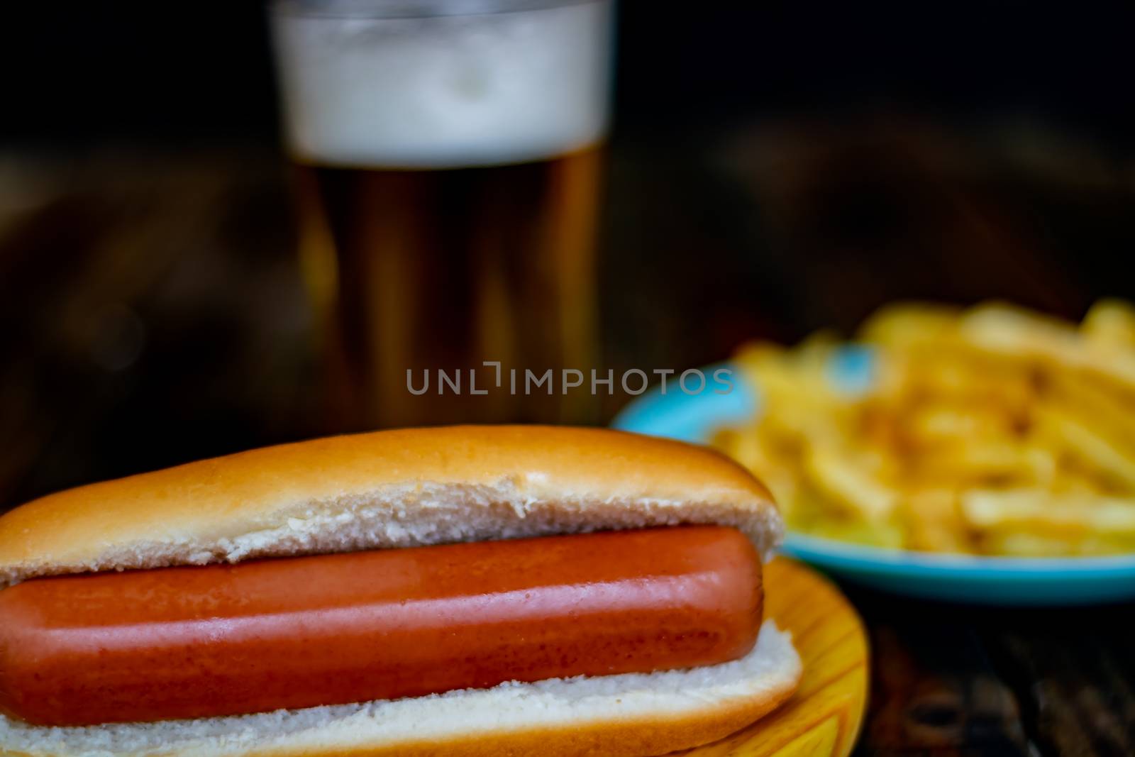 Hot dog and chips on wooden background