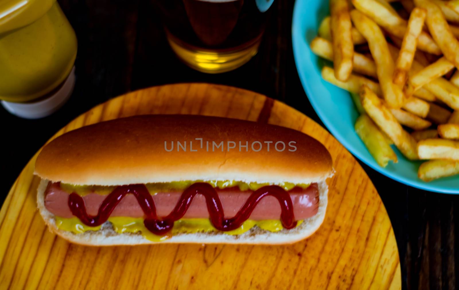 Hot dog and chips on wooden background