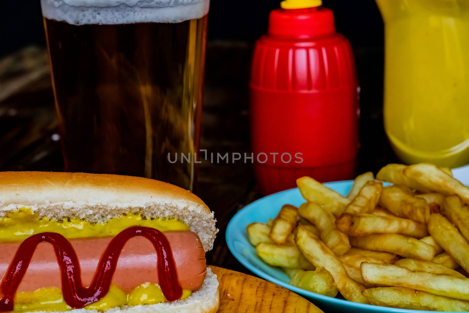 Hot dog and chips on wooden background