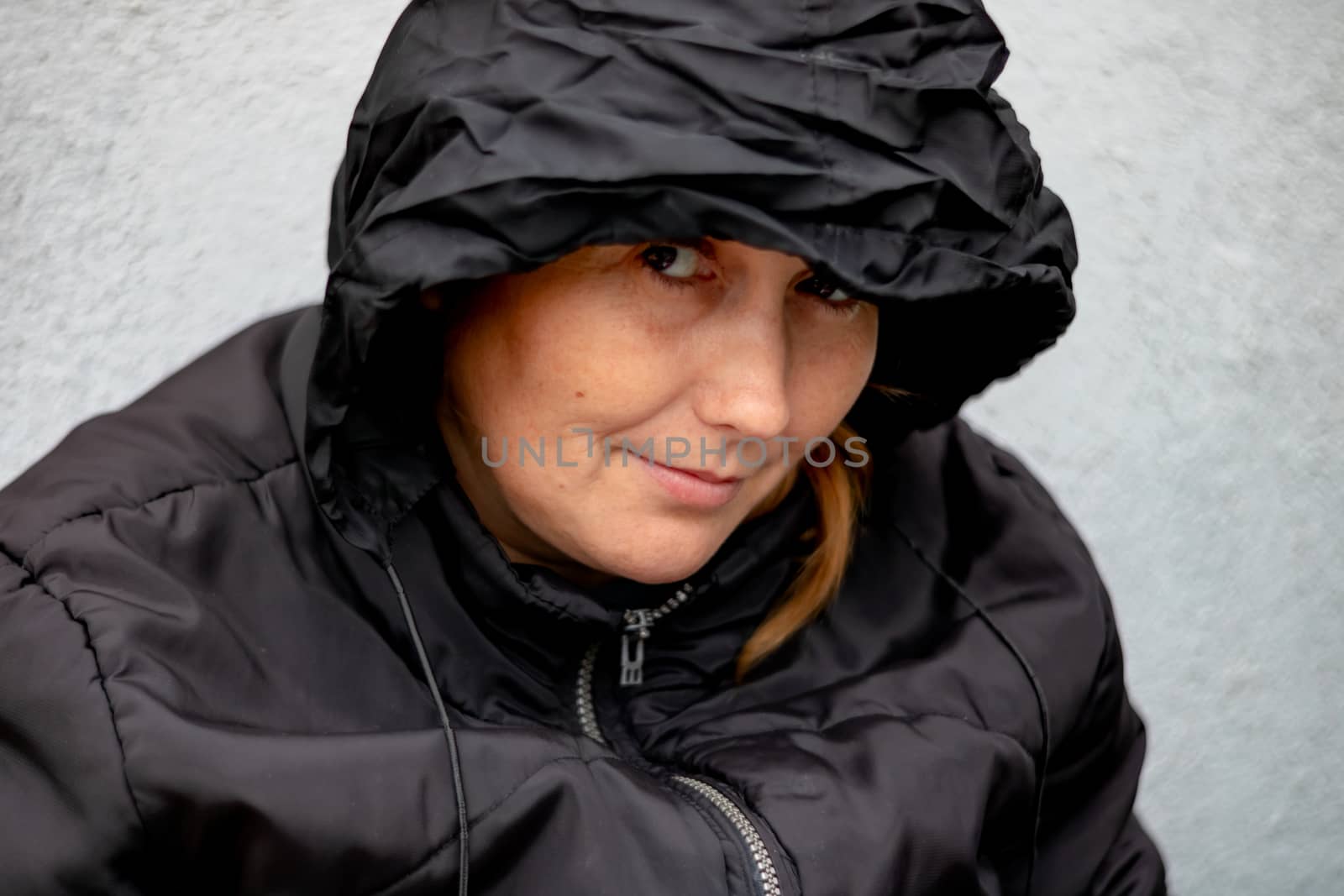 Woman with black hood in a yard