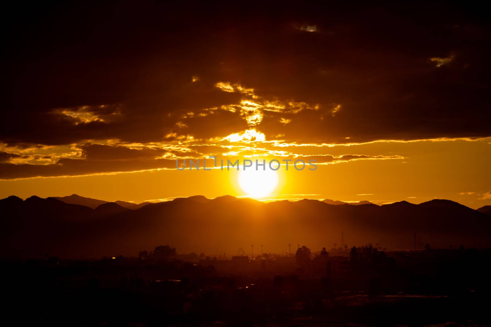 Sunset over mountains with storms clouds