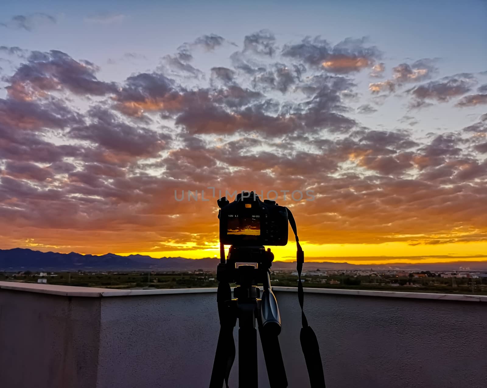 Sunset over mountains with storms clouds