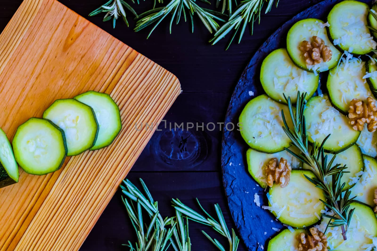 Carpaccio of zucchini with nuts and cheese on dark wooden background