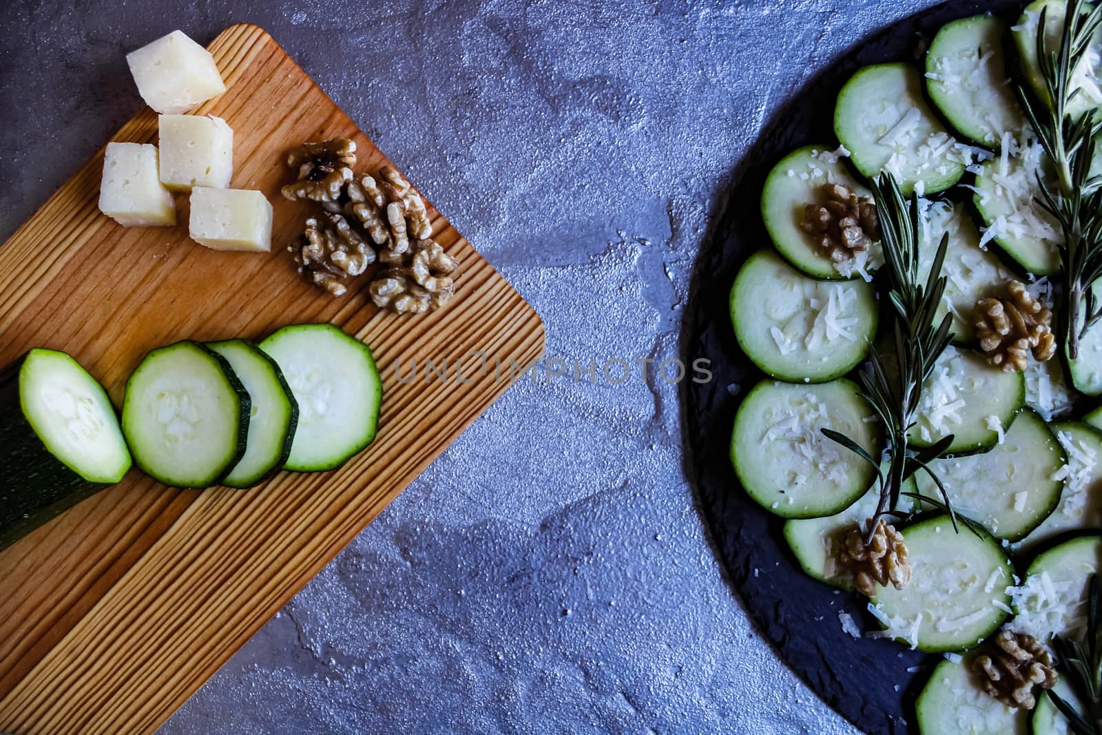 Carpaccio of zucchini with nuts and cheese on gray background