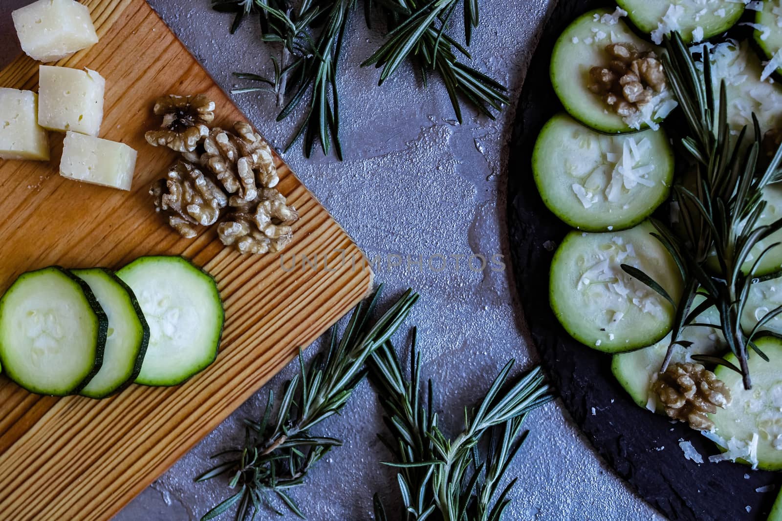 Carpaccio of zucchini with nuts and cheese on gray background